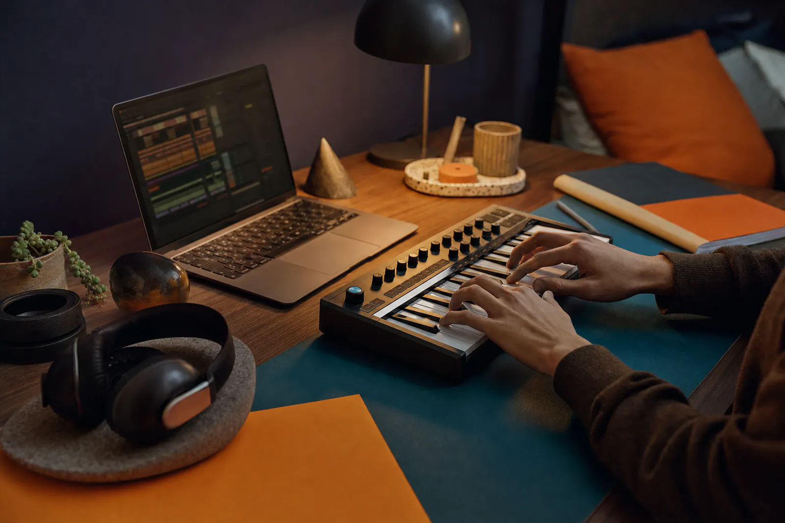 Hands building a first song loop on a MIDI keyboard